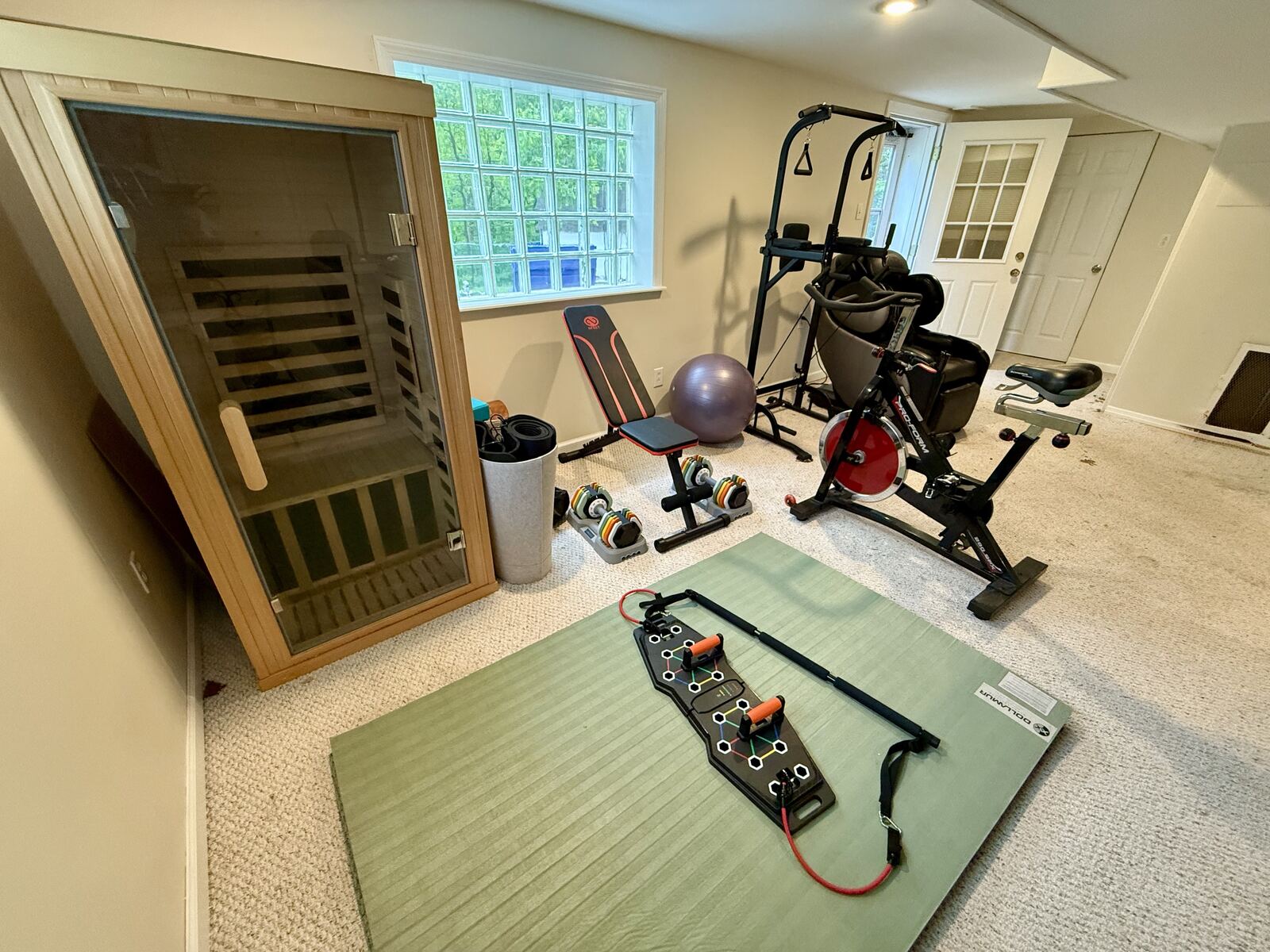 Home gym with exercise bike, sauna and massage chair in furnished rental