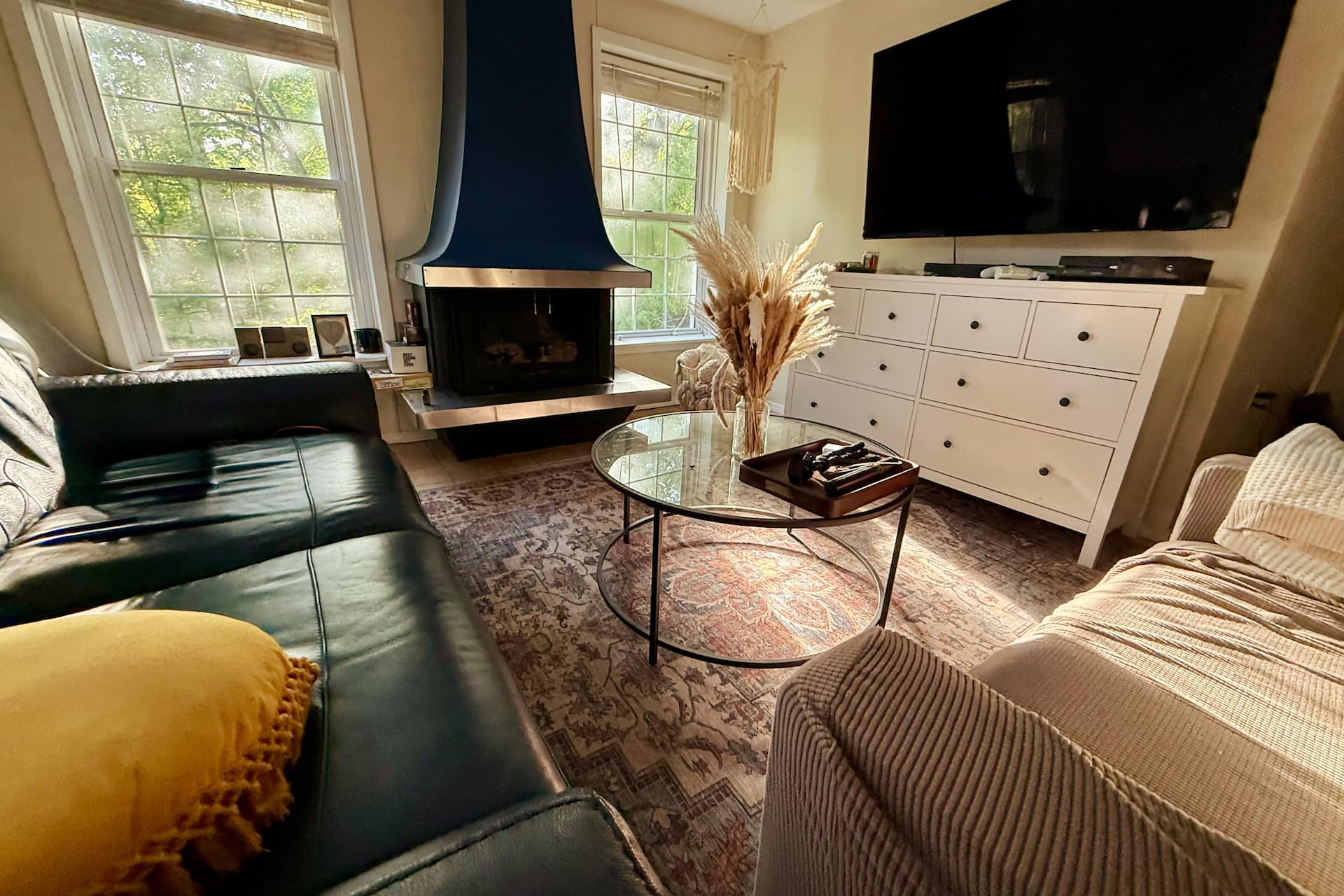 Living room with sofa, TV and fireplace at Urban Spa Retreat